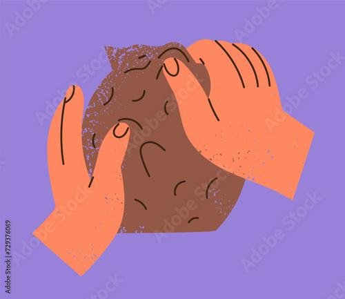 Hands molding a sculpture out of clay