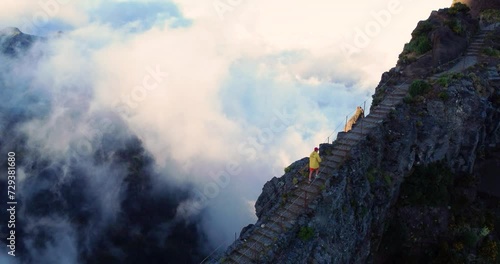 Traveler hiker walking high in the mountains on steep stairs uphill. concept of development and purposefulness. Pico do Ruivo to Pico do Areeira in the Madeira mountains. Portugal photo
