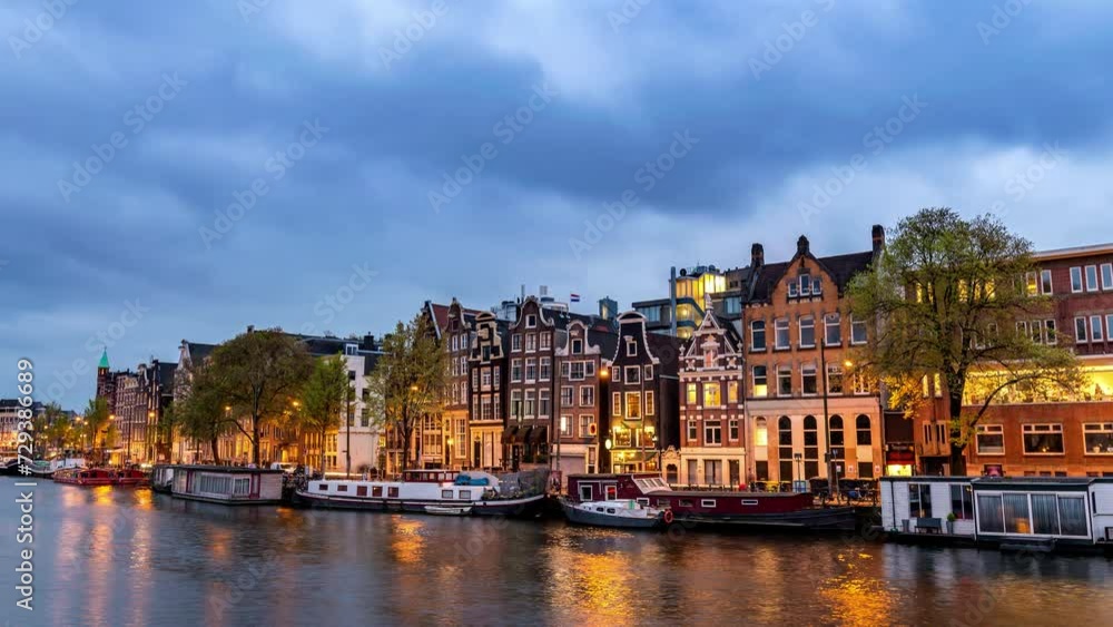Amsterdam Netherlands time lapse, day to night city skyline at canal waterfront Amsterdam Netherlands time lapse, day to night city skyline at canal waterfront