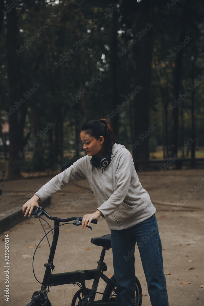 Happy Asian young woman walk and ride bicycle in park, street city her smiling using bike of transportation, ECO friendly, People lifestyle concept.