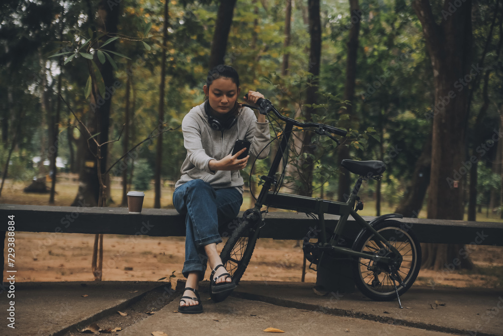 Obraz premium Happy Asian young woman walk and ride bicycle in park, street city her smiling using bike of transportation, ECO friendly, People lifestyle concept.