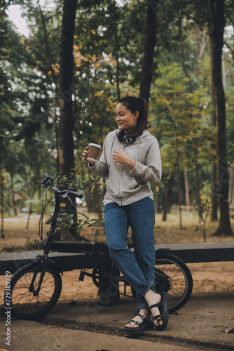 Happy Asian young woman walk and ride bicycle in park, street city her smiling using bike of transportation, ECO friendly, People lifestyle concept.