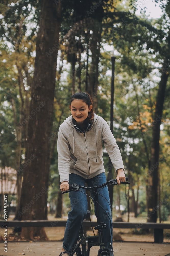 Happy Asian young woman walk and ride bicycle in park, street city her smiling using bike of transportation, ECO friendly, People lifestyle concept. Happy Asian young woman walk and ride bicycle in park, street city her smiling using bike of transportation, ECO friendly, People lifestyle concept.