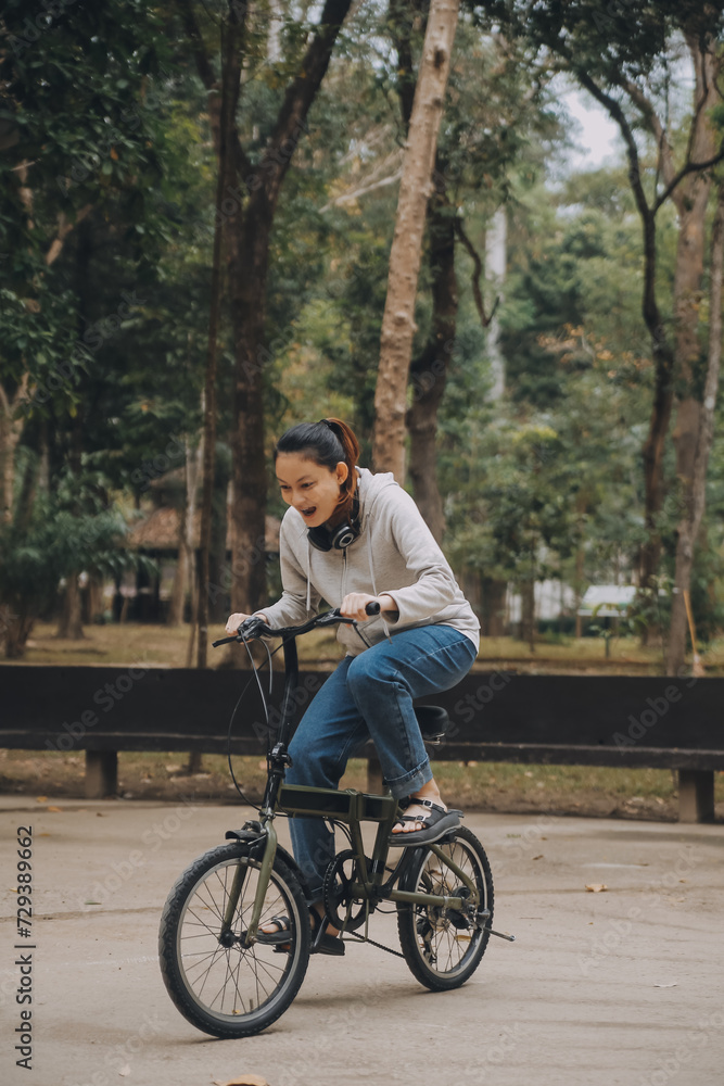 Happy Asian young woman walk and ride bicycle in park, street city her smiling using bike of transportation, ECO friendly, People lifestyle concept. Happy Asian young woman walk and ride bicycle in park, street city her smiling using bike of transportation, ECO friendly, People lifestyle concept.