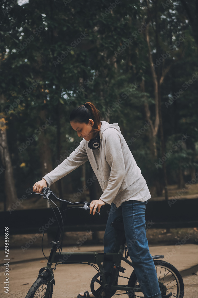 Obraz premium Happy Asian young woman walk and ride bicycle in park, street city her smiling using bike of transportation, ECO friendly, People lifestyle concept.