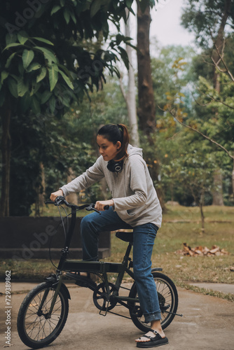 Happy Asian young woman walk and ride bicycle in park, street city her smiling using bike of transportation, ECO friendly, People lifestyle concept.