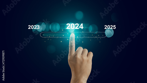 Human hand touch on virtual bar status to change from 2023 to 2024 and 2025 for preparation and focus new business concept, establish goals and a business plan, start new business and new life