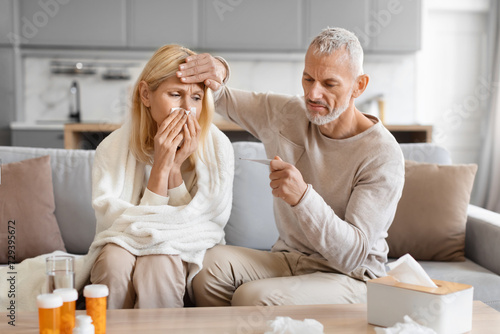 Fotografija Senior man treating his sick wife at home