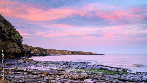 Pink Clouds over Cullernose Point, on the rocky shoreline at Howick on the Northumberland coast, AONB which is now renamed as National Landscapes