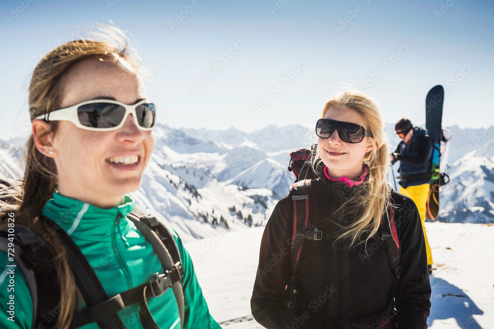 Group of friends celebrating a hike to the top of a peak on skis in winter. Achenkirch, Austria Group of friends celebrating a hike to the top of a peak on skis in winter. Achenkirch, Austria