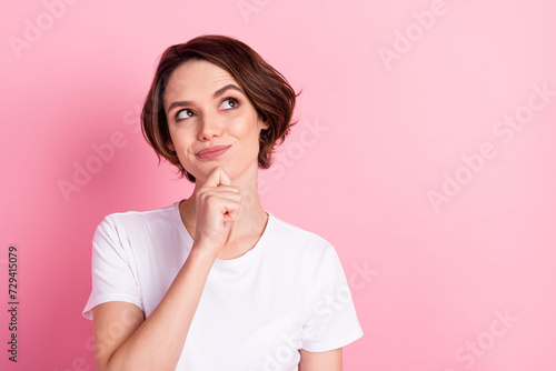 Photo portrait of curious dreamy girl looking empty space isolated pastel pink color background