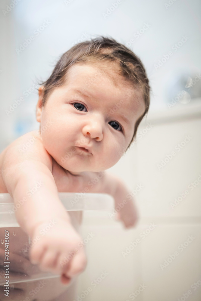 Mother gives her new born baby boy a bath. Munich, Germany Mother gives her new born baby boy a bath. Munich, Germany
