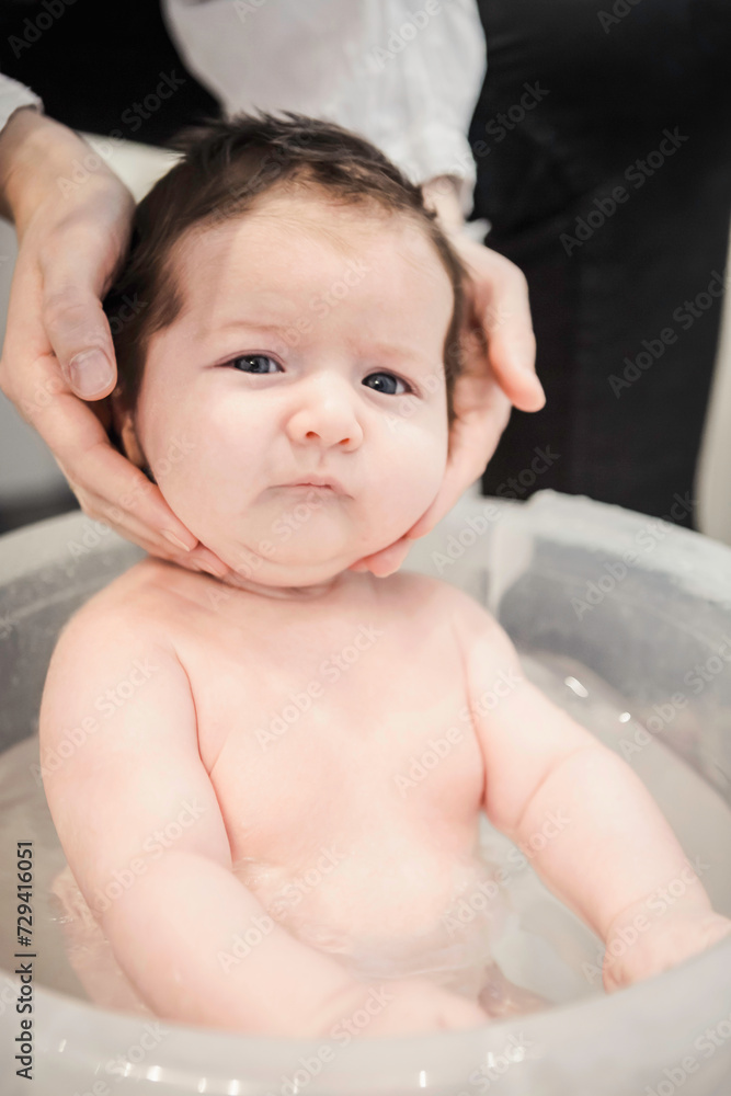 Mother gives her new born baby boy a bath. Munich, Germany Mother gives her new born baby boy a bath. Munich, Germany