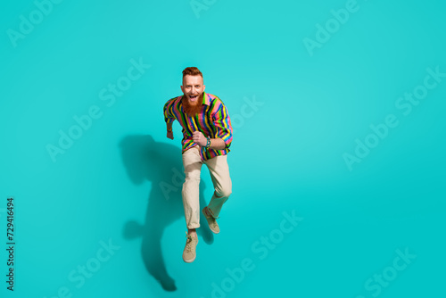 Full length body photo of crazy red hair elegant guy with mustache beard jumping to invite you party isolated on cyan color background
