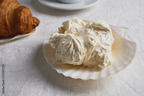 Konstfotografi breakfast with croissant and whipped butter in  shell-shaped plate