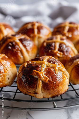 Freshly Baked Hot Cross Buns on round iron cooling rack