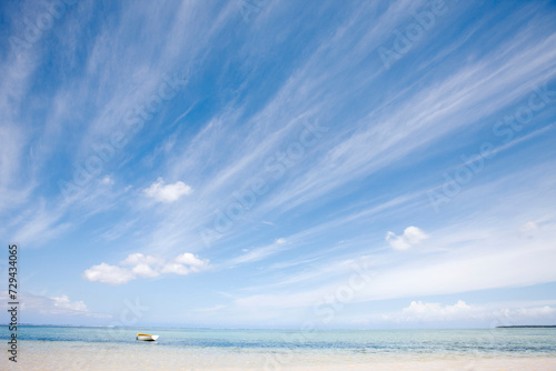 Landscape of beach and large blue sky with yellow boat. Mauritius photo