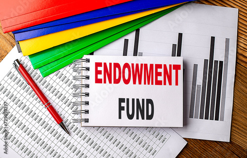 ENDOWMENT FUND text on a notebook with pen, folder on a chart background