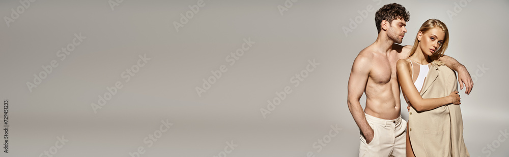 banner of man with hand in pocket putting hand on shoulder of blonde woman in bodysuit and blazer banner of man with hand in pocket putting hand on shoulder of blonde woman in bodysuit and blazer