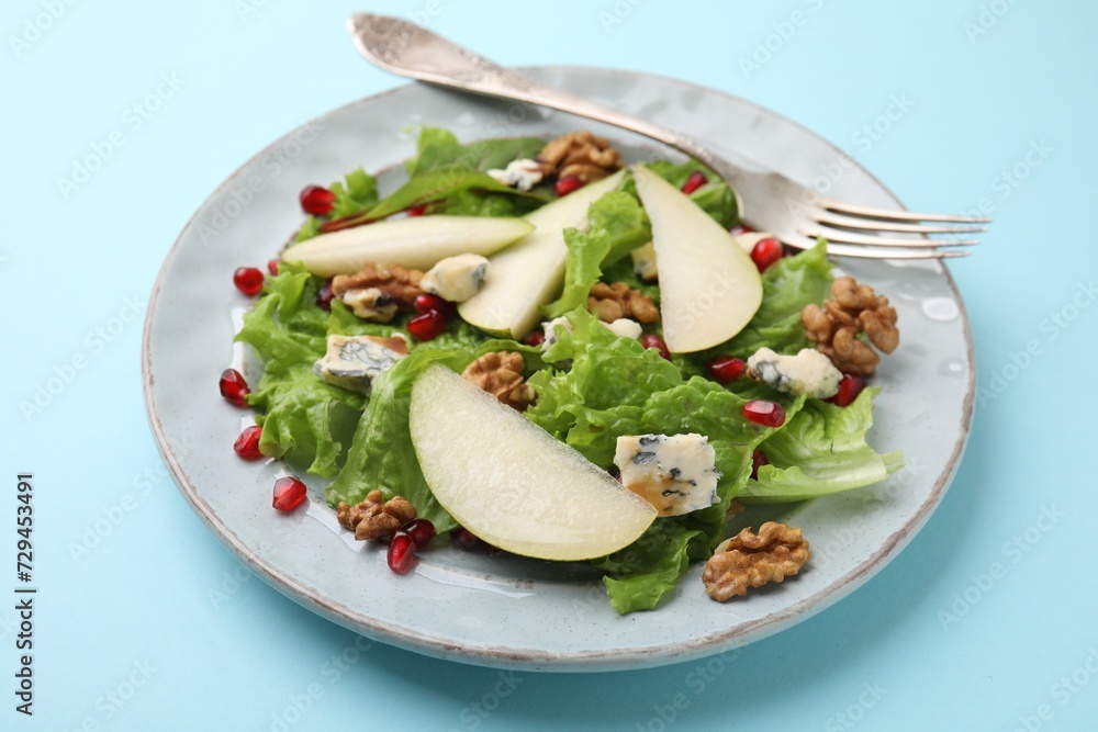 Delicious pear salad on light blue background, closeup Delicious pear salad on light blue background, closeup