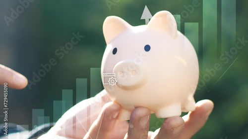 Concept of savings and investments . Piggy bank closeup and icons . Saving money for future and retirement fund, business or finance and investment. Pension, Vacations.Male hand holding piggybank photo