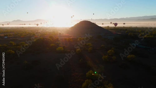 Piramide del Sol Teotihuacan al amanecer vista desde el cielo con globos aerostaticos volando  photo
