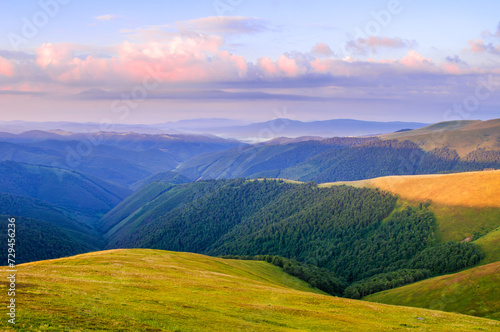 The view at dawn from the top of the mountain on distant mountains and valleys. Ukrainian Carpathians, Borzhava ridge