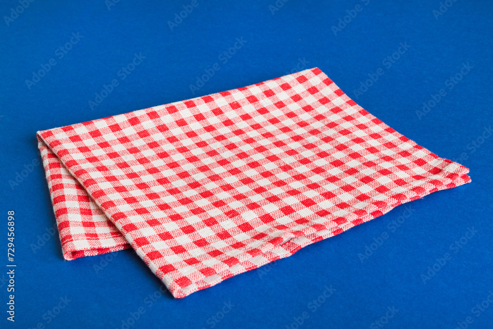 top view with red empty kitchen napkin isolated on table background. Folded cloth for mockup with copy space, Flat lay. Minimal style top view with red empty kitchen napkin isolated on table background. Folded cloth for mockup with copy space, Flat lay. Minimal style