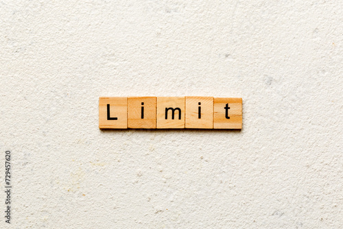 limit word written on wood block. limit text on table, concept