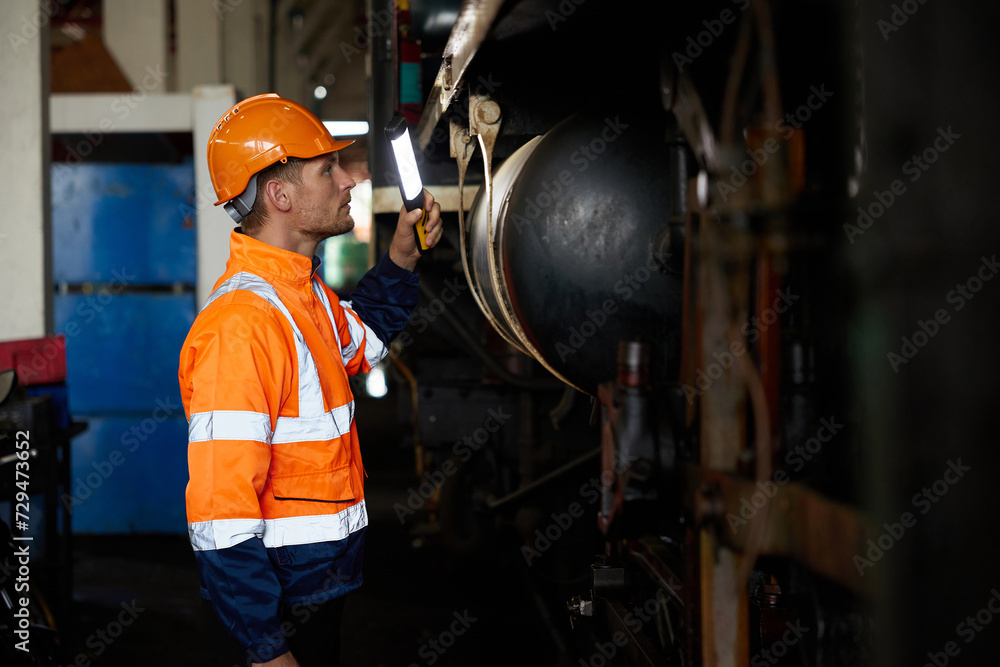engineer or technician using light stick and checking construction train at station engineer or technician using light stick and checking construction train at station