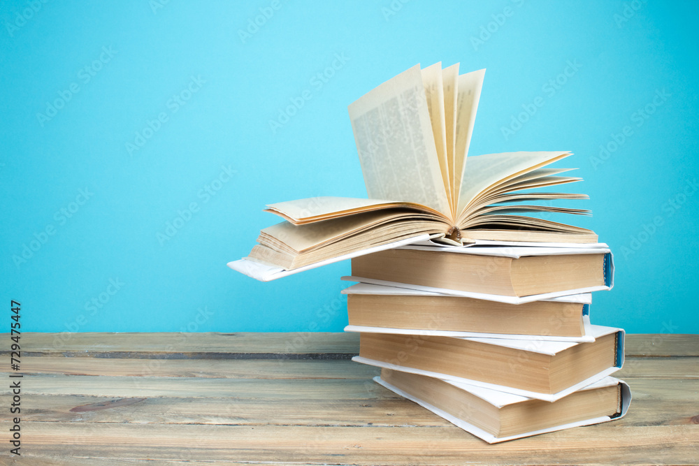 Fototapeta premium open book, books on the blue background. Back to school. Education. Copy space for text.