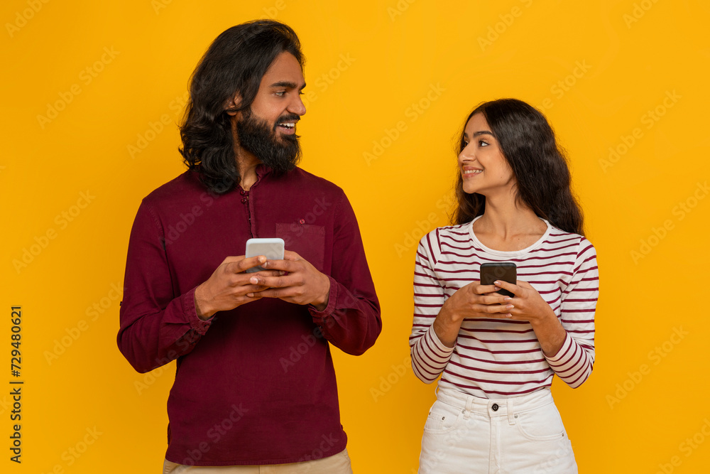 Positive stylish millennials with smartphone in their hands Positive stylish millennials with smartphone in their hands