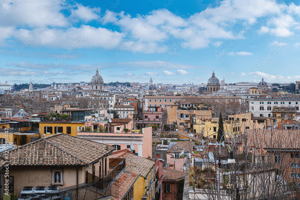 Aerial view of Rome against a blue sky, showcasing the city's majestic skyline.