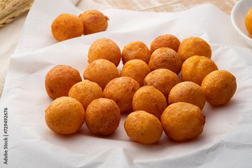 Thai Deep Fried Sweet Potato Balls in white plate. (Khanom khai nok kratha) Thai Deep Fried Sweet Potato Balls in white plate. (Khanom khai nok kratha)