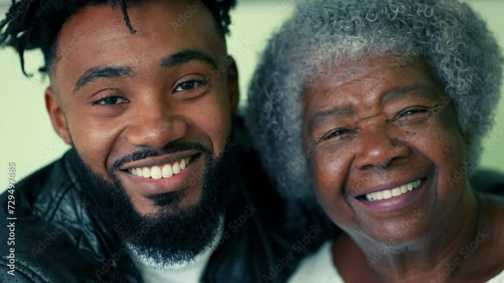 Happy Contrast in Ages - Portrait of Elderly Grandmother in 80s next to her adult 20s son close-up faces smiling at camera Happy Contrast in Ages - Portrait of Elderly Grandmother in 80s next to her adult 20s son close-up faces smiling at camera