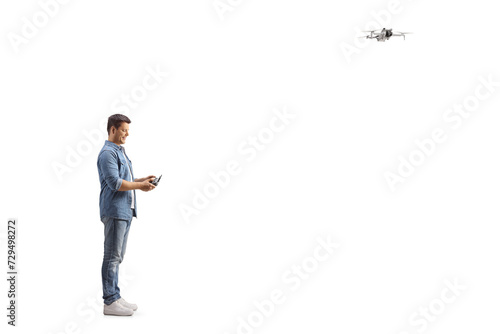 Man flying a drone and looking at the remote cotroller