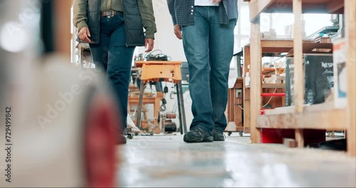 Legs, woodwork and people walking in carpentry workshop together for production or manufacturing. Partner, furniture stock and employee team in studio for art, creative or design for labor project photo