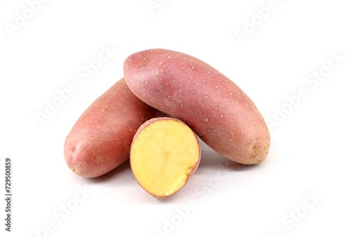 Red potatoes, two whole and one halved, on white background.
