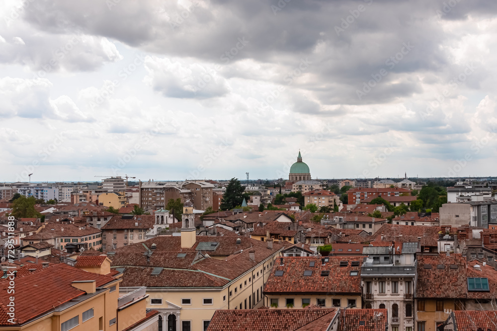 Aerial panoramic view of historic city of Udine, Friuli Venezia Giulia, Italy, Europe. Viewing platform form castle of Udine. Dark clouds on overcast day. Classical Italian architecture red roofs