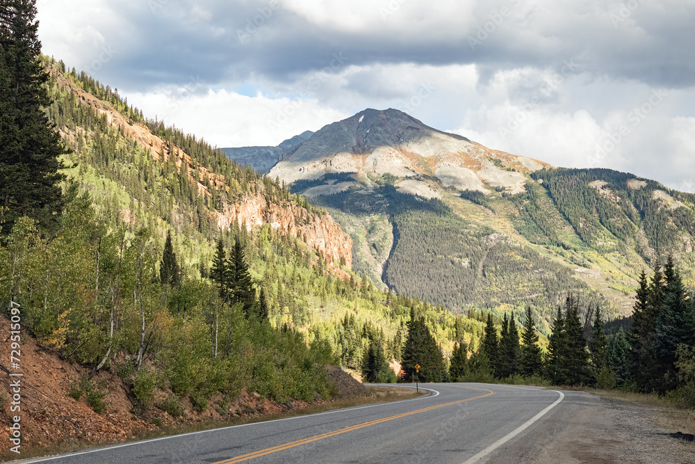 Fototapeta premium Asphalt deserted road through the Rocky Mountains autumn landscape of Colorado, USA. 