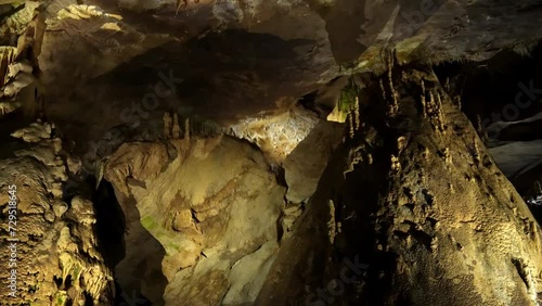 Prometheus (Kumistavi) cave near Tskaltubo and Kutaisi. Imereti Region. Natural monument with hanging stone curtains, stalactites and stalagmites, colorful illuminated rock formations. photo