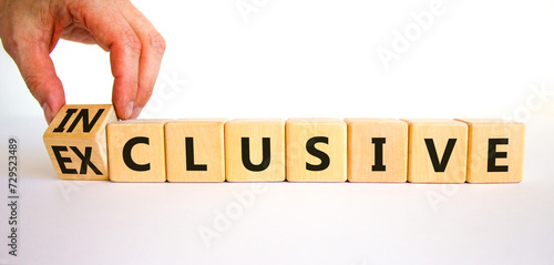 Inclusive or exclusive symbol. Concept word Exclusive and Inclusive on wooden cubes. Businessman hand. Beautiful white table white background, copy space. Business inclusive or exclusive concept. photo