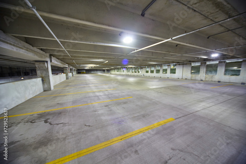 Deserted Urban Parking Garage with Fluorescent Lighting, Wide-Angle View