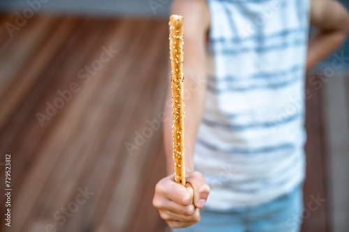 Child holding a grissini bred stick