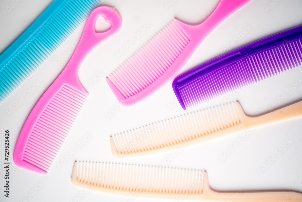 multi-colored hair combs on a white background