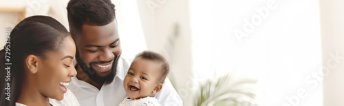 Happy African family with baby smiling at home, expressing joy and togetherness, with natural light and soft background, in a candid moment. Reproductive health, IVF.