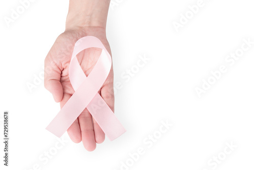 Pink satin ribbon on the palm of a woman, isolated on a white background. Cancer awareness symbol, women's health, breast cancer. copy space.