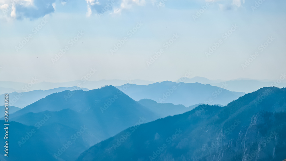 Scenic view of silhouettes of mountains seen from Allakogel in Hochschwab region, Styria, Austria. Wanderlust in wilderness of Austrian Alps, Europe. Panorama of Fischbacher Alpen and Muerztal valley