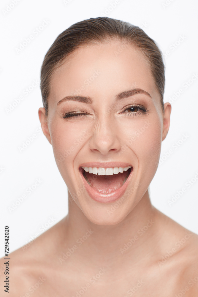 Portrait, smile and woman wink for skincare, flirt or beauty makeup isolated on white studio background. Face, blink and happy model in cosmetics excited for spa facial treatment for healthy skin Portrait, smile and woman wink for skincare, flirt or beauty makeup isolated on white studio background. Face, blink and happy model in cosmetics excited for spa facial treatment for healthy skin
