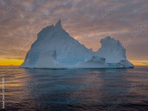 Wallpaper Mural A huge high breakaway glacier drifts in the southern ocean off the coast of Antarctica at sunset, the Antarctic Peninsula, the Southern Arctic Circle, azure water, cloudy weather Torontodigital.ca